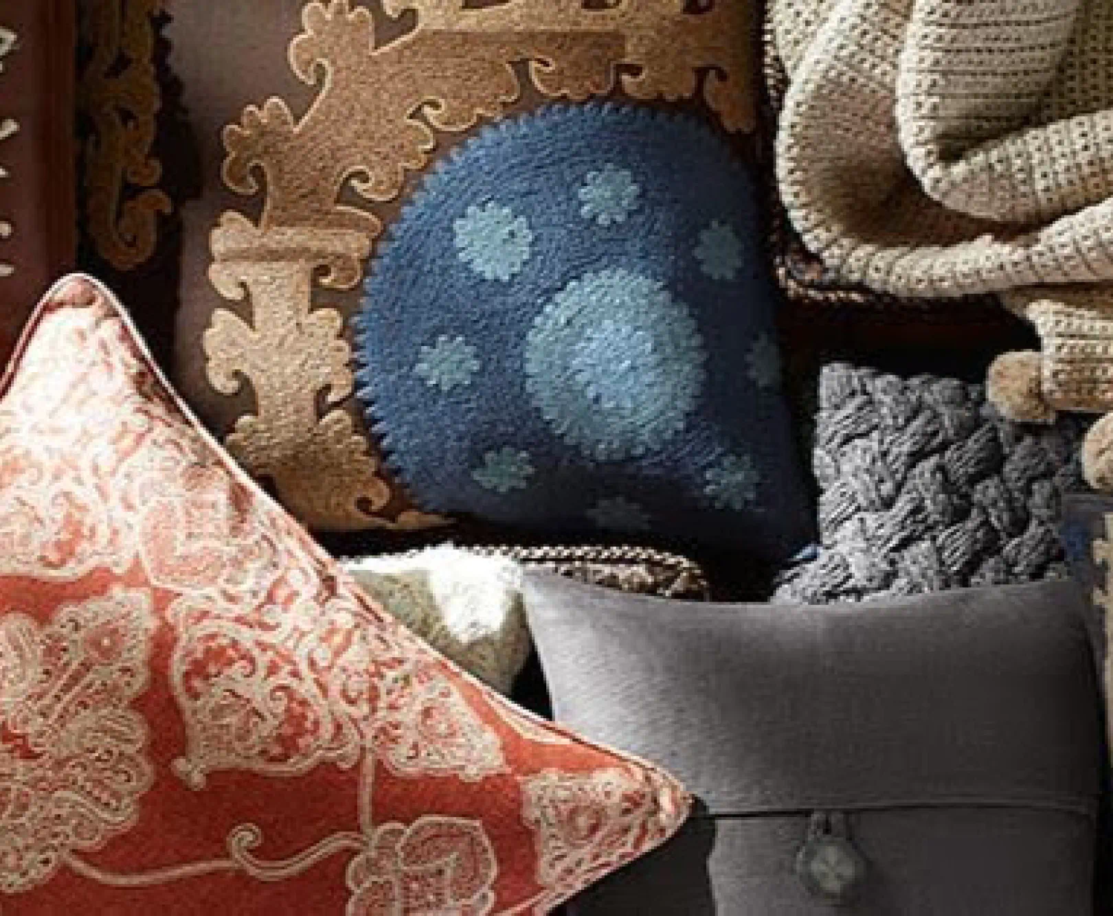 A collection of throw pillows in a range of several fabrics.