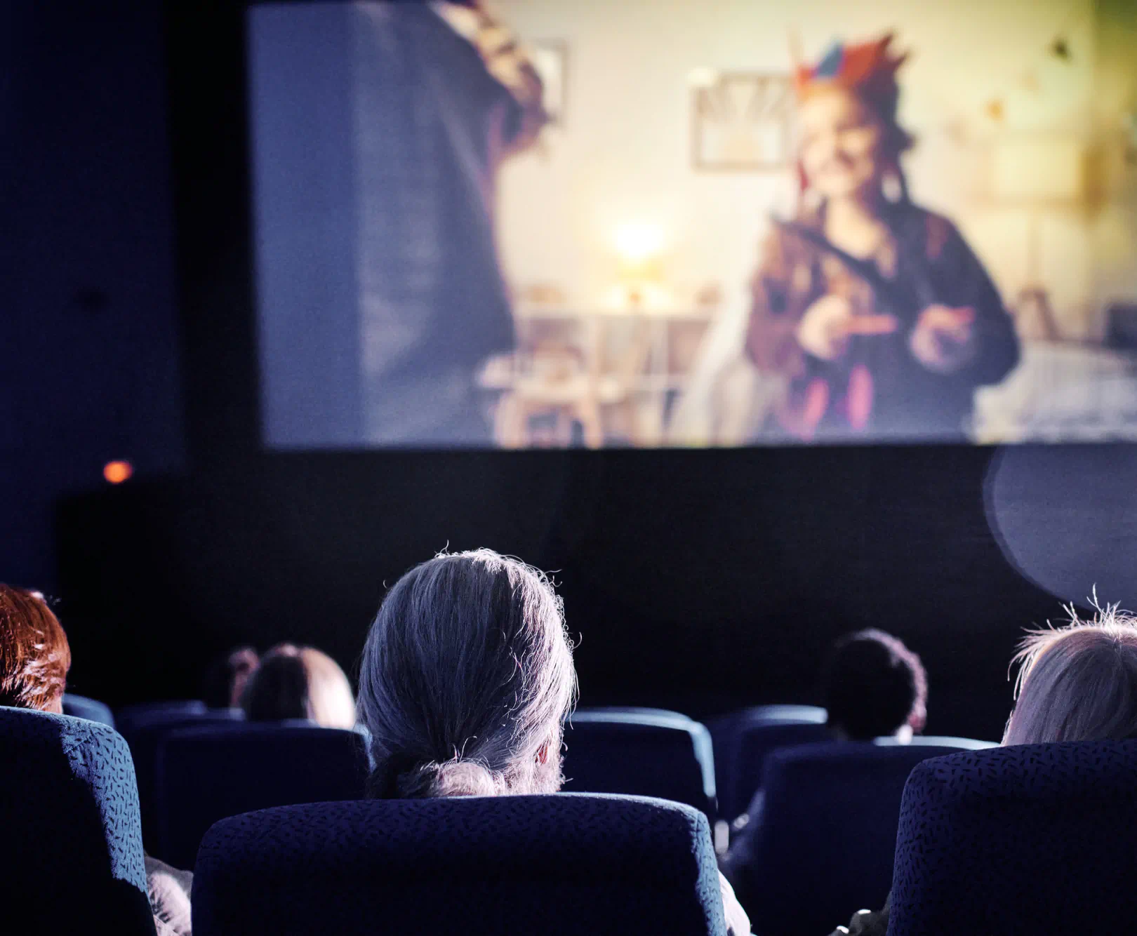 People in a movie theater watching a film