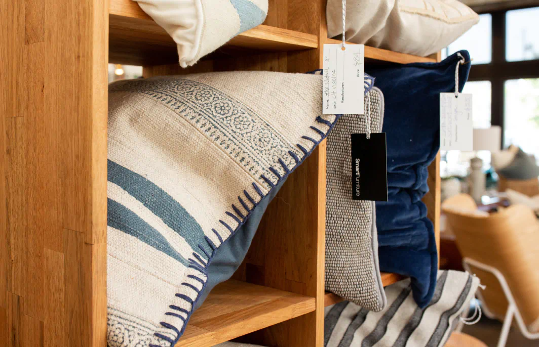 interior of a home goods store with a display of decorative pillows