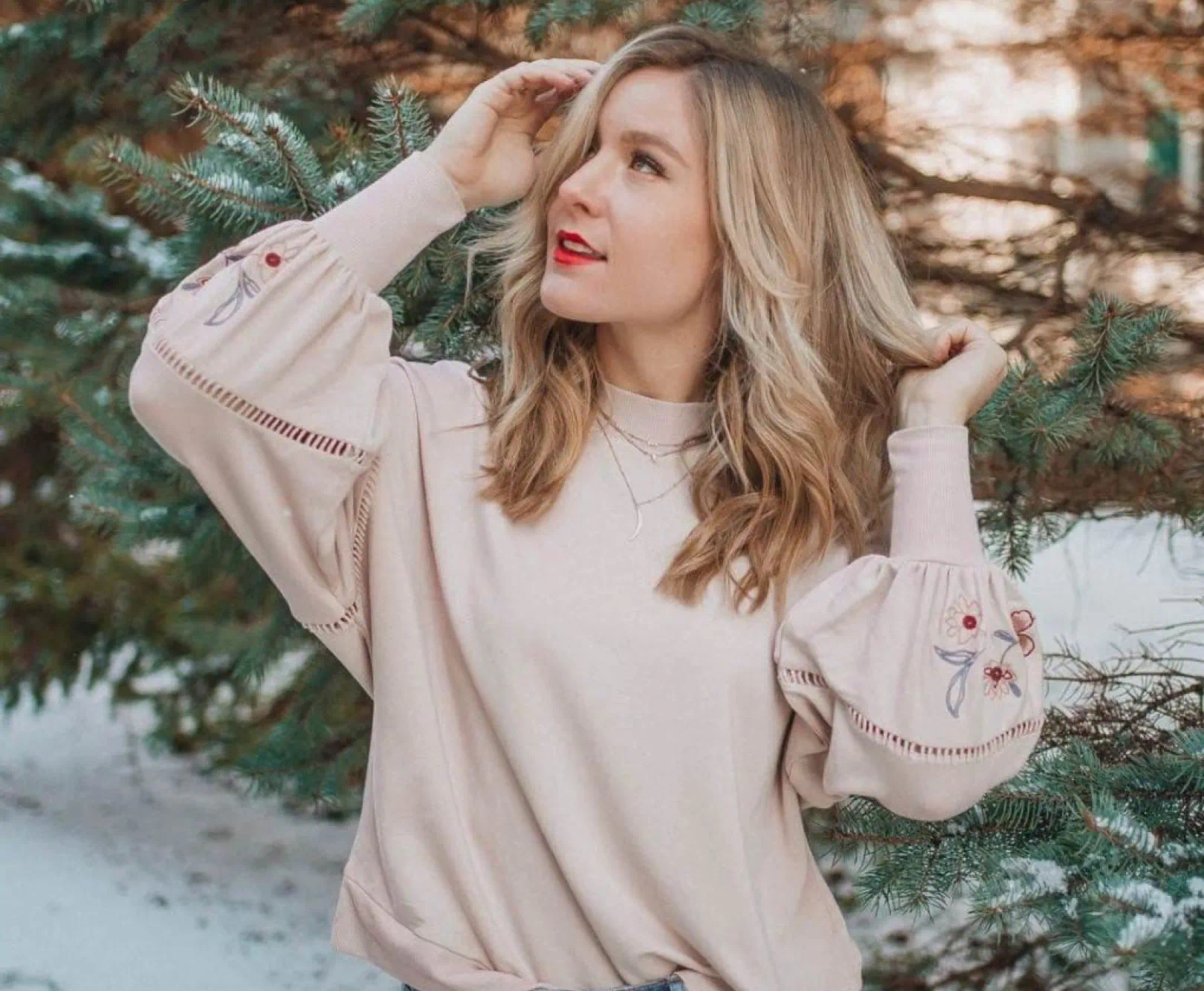 person looking up in tan blouse