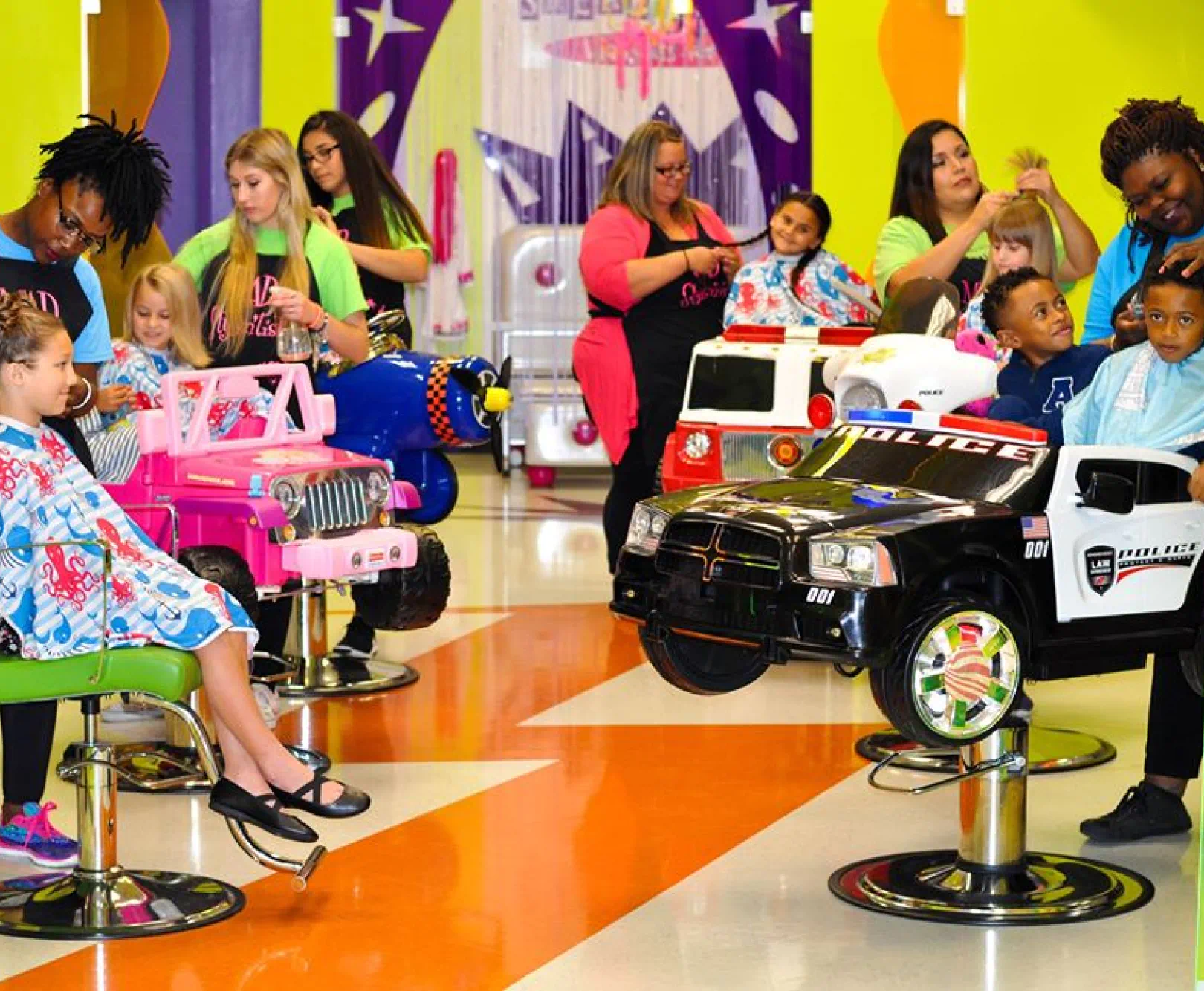 children getting haircuts in fun chairs