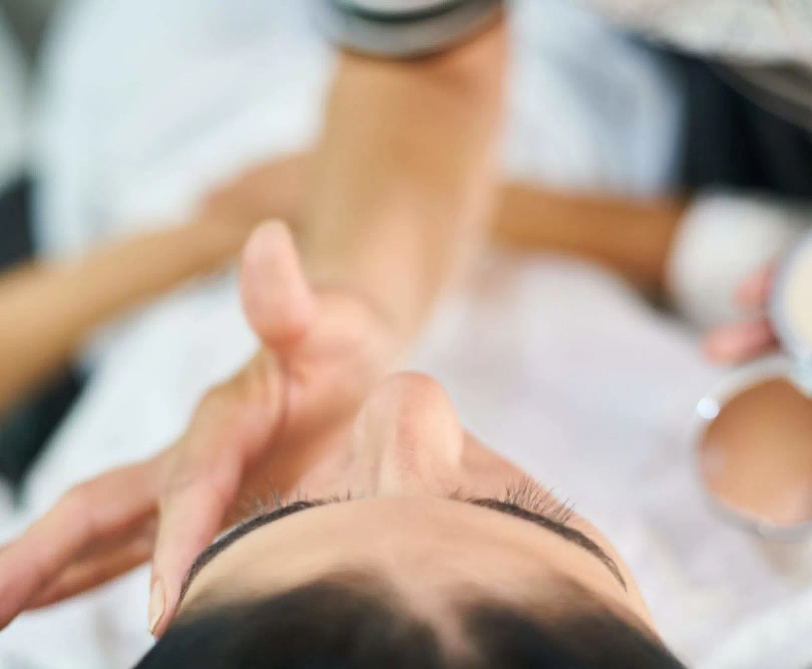 person touching client's eyebrow