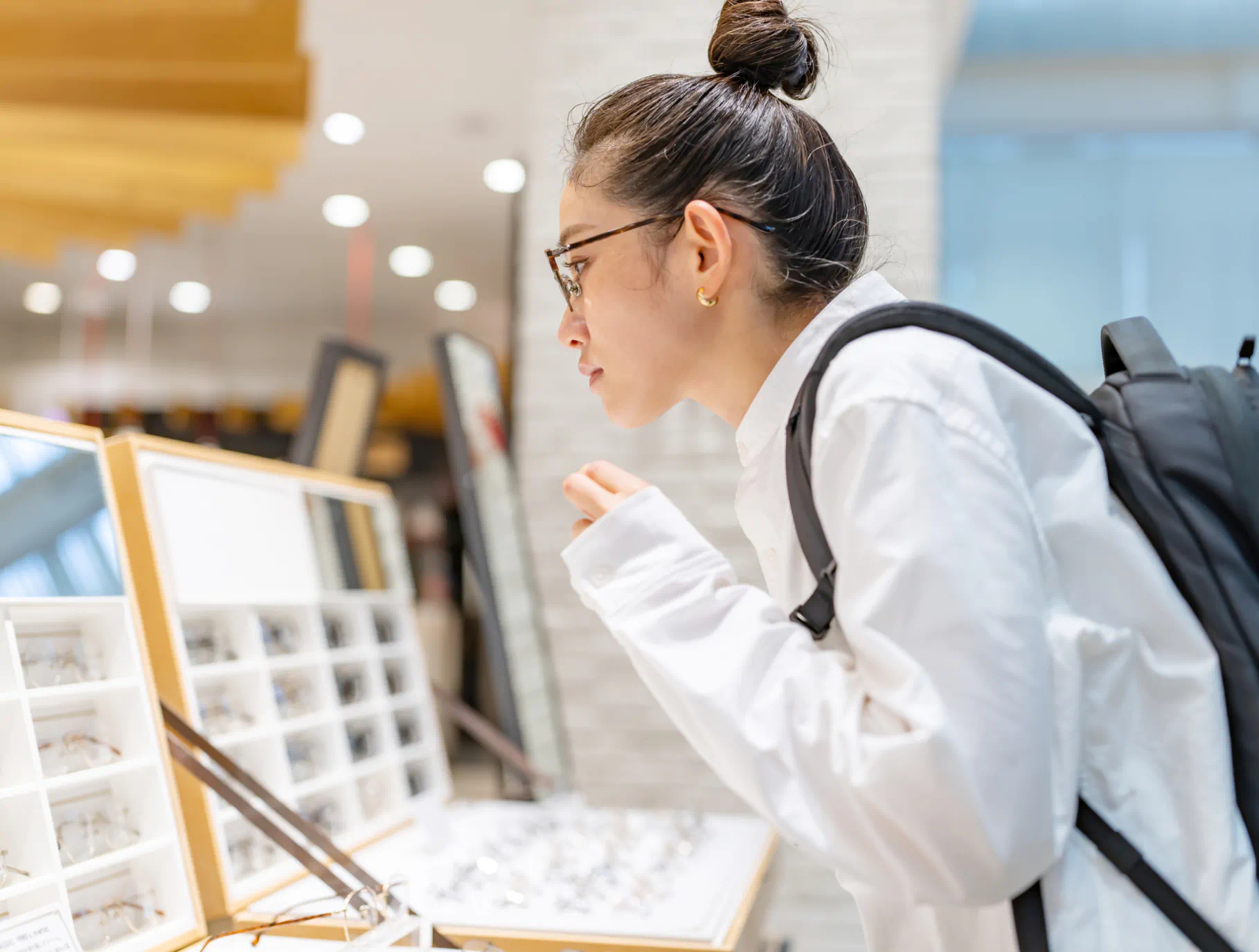 Person trying on glasses.