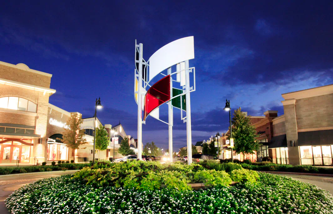 Colorful glass and metal structure at the center of the roundabout in front of Summit Fair.